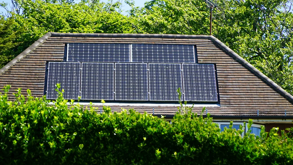 Solar panels covering a residential roof on a clear day